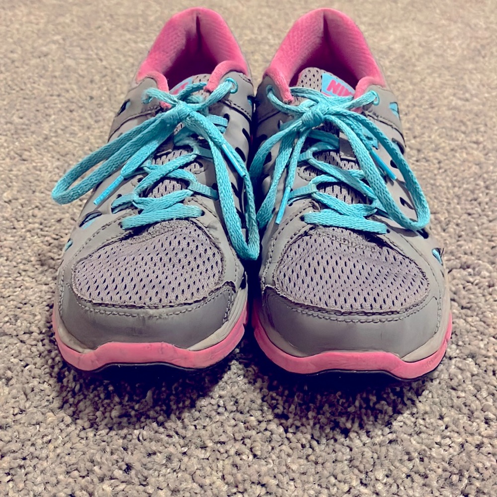 Grey/pink Nike running shoes. Size 7.